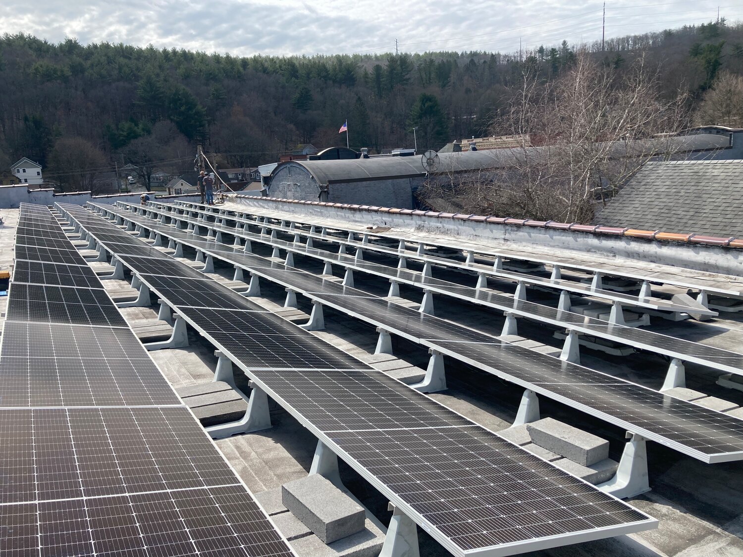 For flat or nearly-flat roofs like one on the Ritz Company Playhouse, ballasted racks for solar panels are used to avoid penetrating the roof's rubber membrane.